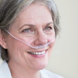 woman smiling with nasal cannula on