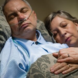 woman and man sleeping with nasal cannula on